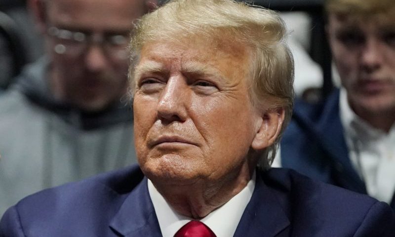 FILE - Former President Donald J. Trump watches the NCAA Wrestling Championships, Saturday, March 18, 2023, in Tulsa, Okla. Trump’s calls for protests ahead of his anticipated indictment in New York have generated mostly muted reactions from supporters, with even some of his most ardent loyalists dismissing the idea as a waste of time or a law enforcement trap. (AP Photo/Sue Ogrocki, File)