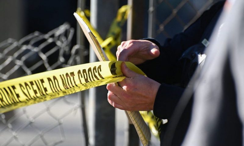 A San Mateo County Sheriff officer puts up police tape at a crime scene after a shooting at the Spanish Town shops in Half Moon Bay, California, on January 24, 2023. - A suspected gunman was in custody Monday over the killing of seven people in a rural community in northern California, just two days after a mass shooting at a Lunar New Year celebration near Los Angeles. (Photo by Samantha Laurey / AFP) (Photo by SAMANTHA LAUREY/AFP via Getty Images)
