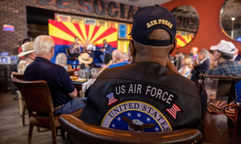 SCOTTSDALE, ARIZONA - NOVEMBER 02: Veterans listen as Republican nominee for Arizona governor Kari Lake speaks at the Social Tap sports bar on November 02, 2022 in Scottsdale, Arizona. The campaign event, part of Lake's "Ask Me Anything Tour" was hosted by Veterans for Kari. (Photo by John Moore/Getty Images)