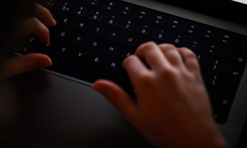 In this photo illustration, a teenage child looks at a screen of age-restricted content on a laptop screen on January 17, 2023 in London, England. The Bill aims to protect young and vulnerable viewers by introducing new rules for social media companies which host user-generated content, and for search engines, which will have tailored duties focussed on minimising the presentation of harmful search results. Content that platforms will need to remove includes child sexual abuse material, revenge pornography, selling illegal drugs or weapons, and terrorism. (Photo by Leon Neal/Getty Images)
