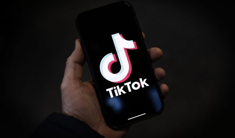 LONDON, ENGLAND - FEBRUARY 28: In this photo illustration, a TikTok logo is displayed on an iPhone on February 28, 2023 in London, England. This week, the US government and European Union's parliament have announced bans on installing the popular social media app on staff devices. (Photo by Dan Kitwood/Getty Images)