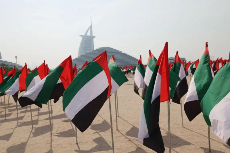 A flag garden in the colours of the United Arab Emirates is set up along the beach in front of the Burj Al-Arab building, to celebrate the annual UAE flag day in Dubai on November 3, 2023. (Photo by Giuseppe CACACE / AFP) (Photo by GIUSEPPE CACACE/AFP via Getty Images)