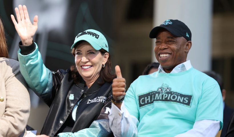 NEW YORK, NEW YORK - OCTOBER 24: Governor of New York Kathy Hochul (L) and New York City Mayor Eric Adams react on stage during the New York Liberty Championship ticker tape parade celebrating winning the 2024 WNBA Finals on October 24, 2024 in New York City. NOTE TO USER: User expressly acknowledges and agrees that, by downloading and/or using this photograph, user is consenting to the terms and conditions of the Getty Images License Agreement. (Photo by Elsa/Getty Images)