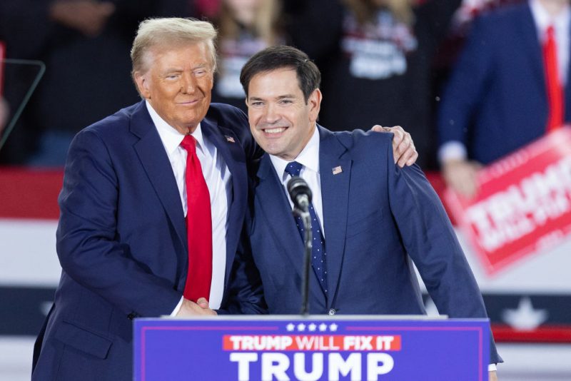 Former US President and Republican presidential candidate Donald Trump greets Senator Marco Rubio, Republican of Florida, during a campaign rally at the J.S. Dorton Arena in Raleigh, North Carolina, on November 4, 2024. Bitter rivals Kamala Harris and Donald Trump embark on a final frenzied campaign blitz Monday with both hitting must-win Pennsylvania on the last day of a tight and volatile US presidential election campaign. (Photo by Ryan M. Kelly / AFP) (Photo by RYAN M. KELLY/AFP via Getty Images)