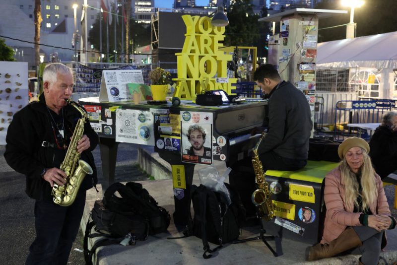 Musicians play in front of an installation set up on a square outside the Tel Aviv Museum of Art, now informally called the "Hostages Square", in Tel Aviv on January 16, 2025. Israel said on January 15 that several points in the Gaza ceasefire and hostage release deal still needed to be resolved but expected them to be finalised even as news spread that an agreement with Hamas had been reached. (Photo by Jack GUEZ / AFP) (Photo by JACK GUEZ/AFP via Getty Images)