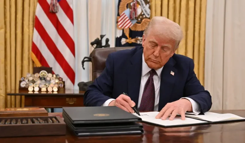 US President Donald Trump signs an executive order to declassify files of former President John F. Kennedy, former Attorney General Robert F. Kennedy and civil rights leader Martin Luther King Jr., in the Oval Office of the White House in Washington, DC, on January 23, 2025. (Photo by ROBERTO SCHMIDT / AFP) (Photo by ROBERTO SCHMIDT/AFP via Getty Images)