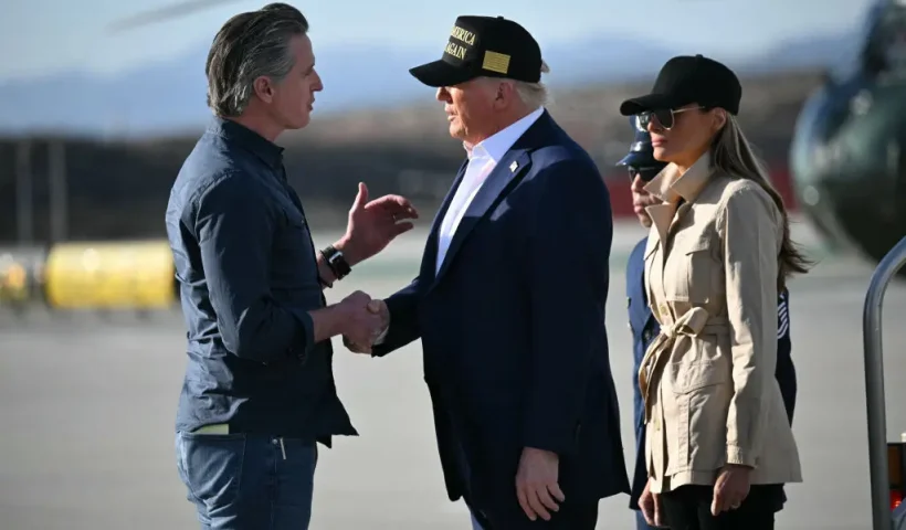 TOPSHOT - US President Donald Trump followed by First Lady Melania Trump, shakes hands with California Governor Gavin Newsom upon arrival at Los Angeles International Airport in Los Angeles, California, on January 24, 2025, to visit the region devastated by the Palisades and Eaton fires. (Photo by Mandel NGAN / AFP) (Photo by MANDEL NGAN/AFP via Getty Images)
