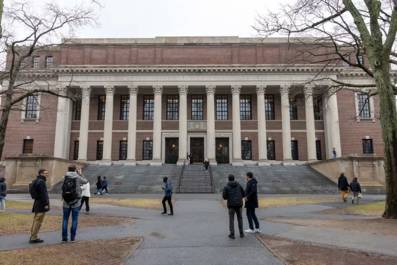 CAMBRIDGE, MASSACHUSETTS - MARCH 17: People gather outside Widener Library on Harvard University's campus on March 17, 2025 in Cambridge, Massachusetts. Harvard University announced free tuition for students from families that make under $200K a year. (Photo by Scott Eisen/Getty Images)