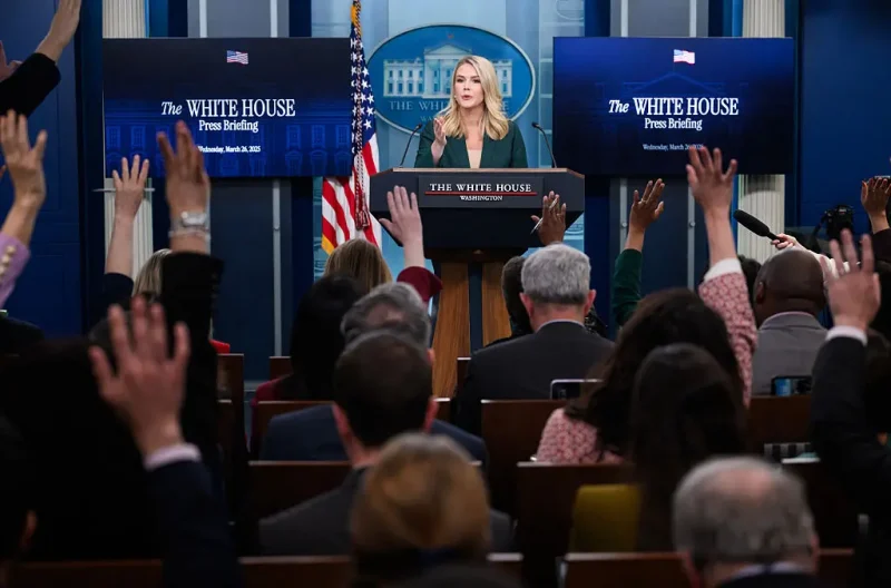 Reporters raise their hand to ask a question as White House Press Secretary Karoline Leavitt speaks during the daily briefing in the Brady Briefing Room of the White House in Washington, DC, on March 26, 2025. (Photo by MANDEL NGAN / AFP) (Photo by MANDEL NGAN/AFP via Getty Images)
