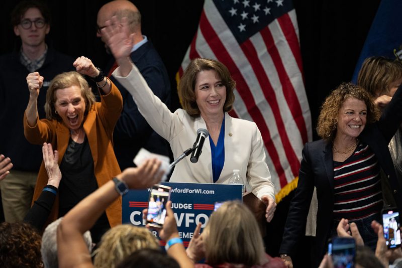 MADISON, WISCONSIN - APRIL 01: Dane County Circuit Court Judge Susan Crawford, flanked by Wisconsin Supreme Court justices, accepts victory in her race for Wisconsin Supreme Court justice on April 01, 2025 in Madison, Wisconsin. The former prosecutor ran against Judge Brad Schimel, who was endorsed by President Donald Trump and financially supported by billionaire businessman Elon Musk. (Photo by Scott Olson/Getty Images)