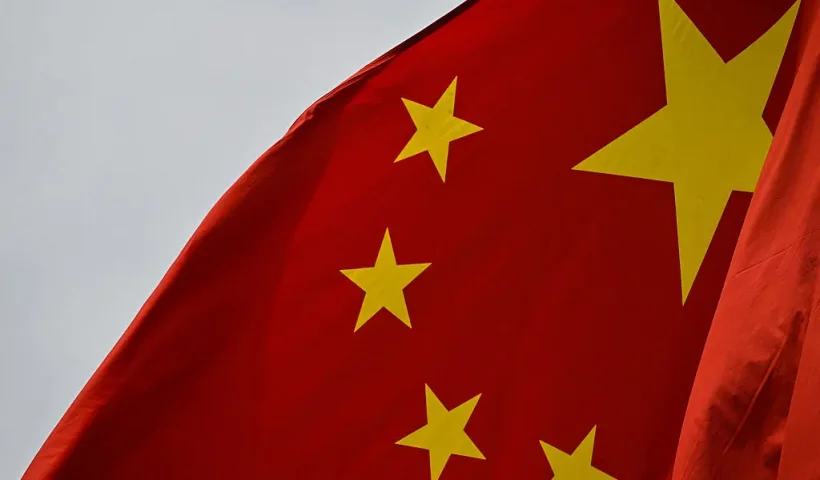 A chinese flag is seen in the financial district of Shanghai on April 7, 2025. Asian equities collapsed on a black Monday on April 7 for markets after China hammered the United States with its own hefty tariffs, ramping up a trade war many fear could spark a recession. (Photo by HECTOR RETAMAL / AFP) (Photo by HECTOR RETAMAL/AFP via Getty Images)