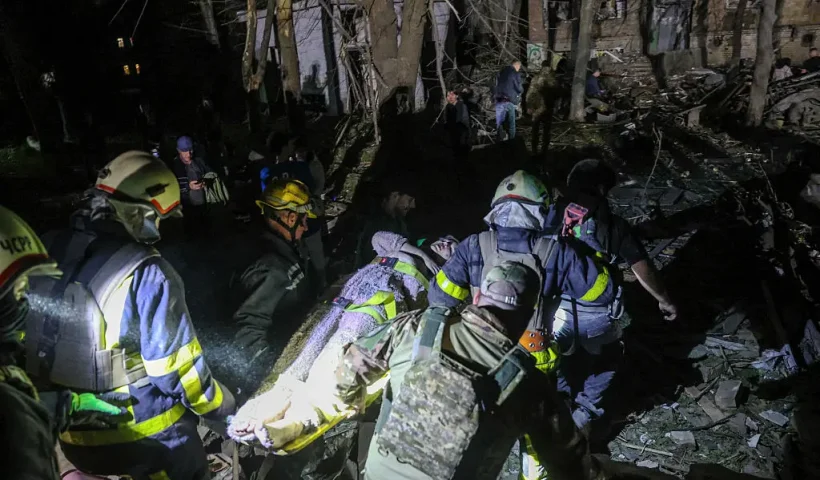 TOPSHOT - Ukrainian rescuers carry a wounded local resident as they operate at the site of a Russian missile attack in Kyiv early on April 24, 2025, amid the Russian invasion of Ukraine. A "massive" Russian missile attack on Kyiv on April 24, 2025, killed at least nine and wounded dozens in one of the deadliest strikes on the Ukrainian capital since Moscow launched its invasion more than three years ago. (Photo by STRINGER / AFP) (Photo by STRINGER/AFP via Getty Images)