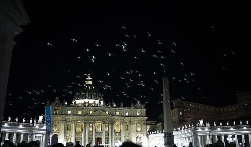 A flock of birds fly over visitors and mourners queueing to access St Peter's Basilica to pay their respects to the late Pope Francis, in The Vatican on April 24, 2025. The Vatican on April 24 said some 61,000 people had already paid their respects to Pope Francis, whose body is lying in state in St Peter's Basilica ahead of his funeral. (Photo by HENRY NICHOLLS / AFP) (Photo by HENRY NICHOLLS/AFP via Getty Images)