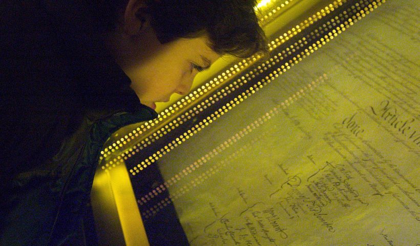 WASHINGTON - DECEMBER 15: Ethan Kasnett, an 8th grade student at the Lab School in Washington, DC, views the original constitution after a ceremony unveiling the people's choice of the top ten most influential documents that shaped the United States of America at the National Archives December 15, 2003 in Washington, DC. The event and vote were co-sponsored by The People's Vote, the National Archives and Records Administration, National History Day, and U.S. News & World Report. Among the records chosen were the Declaration of Independence at number one and the Constitution at number two. (Photo by Brendan Smialowski/Getty Images)