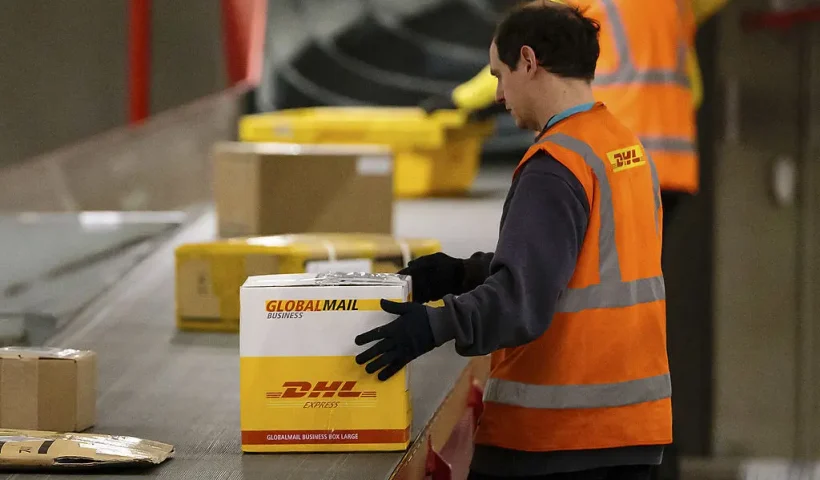 LEIPZIG, GERMANY - FEBRUARY 27: A worker sorts parcels during the night at the DHL hub on February 27, 2014 in Leipzig, Germany. The soon to be expanded hub handles 2,000 tons of cargo or 100.000 parcels and documents per weekday, up to 60 cargo planes land every weeknight. (Photo by Marco Prosch/Getty Images)
