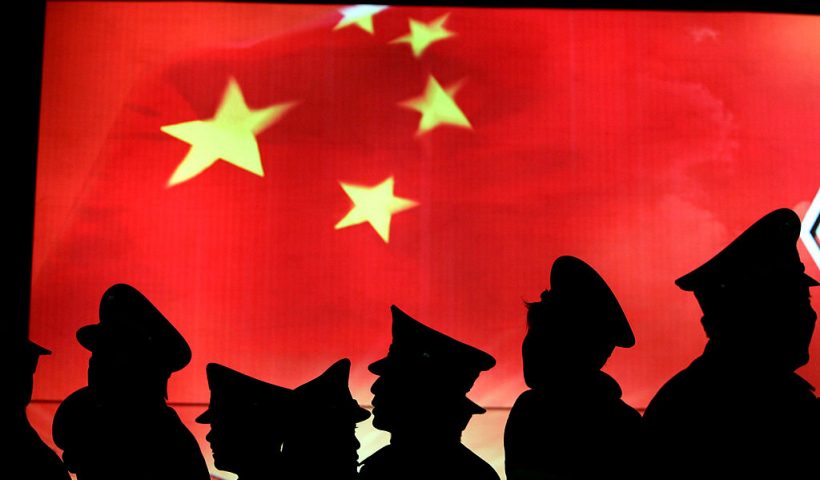 BEIJING, CHINA - MARCH 1: (CHINA OUT) Security guard walk past the Chinese national flag at the Military Museum of Chinese People's Revolution on March 1, 2008 in Beijing, China. From March 1, the Military Museum of Chinese People's Revolution becomes the first national level museum which opens to the public for free in Beijing. (Photo by China Photos/Getty Images)