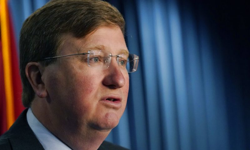 Mississippi Gov. Tate Reeves explains to reporters some of the line items that he vetoed from the appropriations allocated by the state Legislature, Thursday, April 28, 2022, in Jackson, Miss. (AP Photo/Rogelio V. Solis)