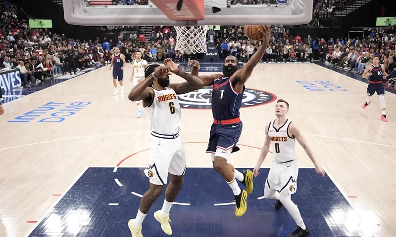 LA Clippers guard James Harden (1) shoots the ball against Denver Nuggets center DeAndre Jordan (6) and guard Christian Braun (0) in the first half during game six of first round for the 2025 NBA Playoffs at Intuit Dome. Mandatory Credit: Kirby Lee-Imagn Images