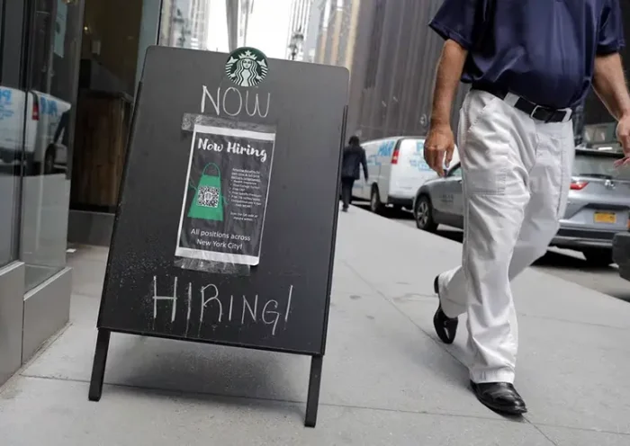 A sign advertising job openings is seen outside of a Starbucks in Manhattan, New York City, New York, U.S., May 26, 2021. REUTERS/Andrew Kelly/File Photo