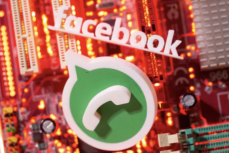 3D printed Whatsapp and Facebook logos are placed on a computer motherboard in this illustration taken January 21, 2021. REUTERS/Dado Ruvic/Illustration