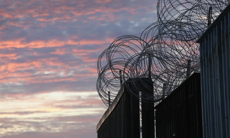 TIJUANA, MEXICO - NOVEMBER 16: Razor wire tops the U.S.-Mexico border fence on November 16, 2018 in Tijuana, Mexico. U.S. border agencies continued to fortify the fence with razor wire and additional personnel as members of the migrant caravan arrived to Tijuana across the border from San Diego, CA. (Photo by John Moore/Getty Images)