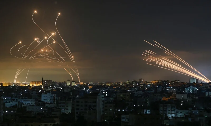 TOPSHOT - The Israeli Iron Dome missile defence system (L) intercepts rockets (R) fired by the Hamas movement towards southern Israel from Beit Lahia in the northern Gaza Strip as seen in the sky above the Gaza Strip overnight on May 14, 2021. - Israel bombarded Gaza with artillery and air strikes on Friday, May 14, in response to a new barrage of rocket fire from the Hamas-run enclave, but stopped short of a ground offensive in the conflict that has now claimed more than 100 Palestinian lives. As the violence intensified, Israel said it was carrying out an attack "in the Gaza Strip" although it later clarified there were no boots on the ground. (Photo by ANAS BABA / AFP) (Photo by ANAS BABA/AFP via Getty Images)
