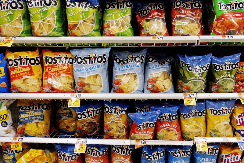 Bags of Tostitos tortilla chips are on display on a supermarket shelf on October 15, 2021, in Arlington, Virginia. (Photo by Olivier DOULIERY / AFP) (Photo by OLIVIER DOULIERY/AFP via Getty Images)