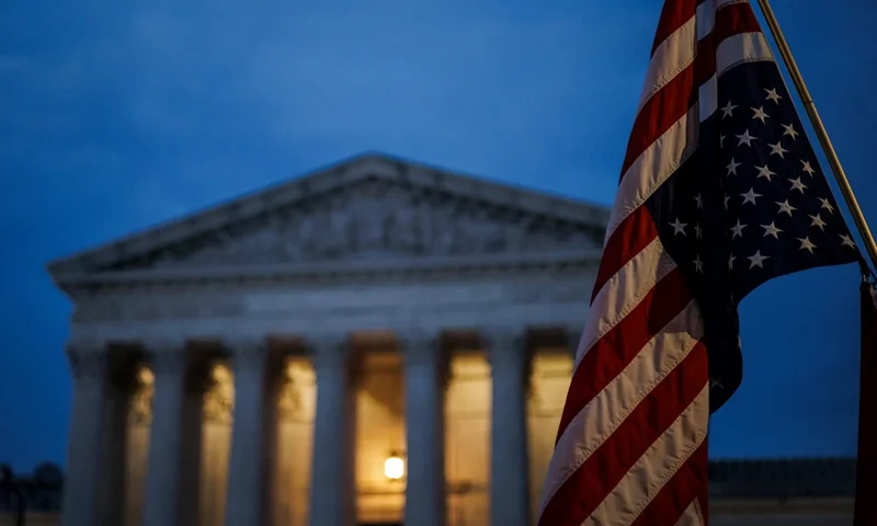 An abortion rights activist flies an upside down US flag, the international sign of distress, outside of the US Supreme Court during a protest in Washington, DC, on June 26, 2022, two days after the US Supreme Court scrapped half-century constitutional protections for the procedure. Elected leaders across the US political divide rallied on June 26 for a long fight ahead on abortion -- state by state and in Congress -- with total bans in force or expected soon in half of the vast country. (Photo by Samuel Corum / AFP) (Photo by SAMUEL CORUM/AFP via Getty Images)