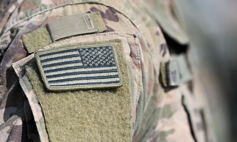 A soldier of the US army wears the country's flag on his uniform during the 'Dynamic Front 22', the US Army led NATO and Partner integrated annual artillery exercise in Europe, in Grafenwoehr, near Eschenbach, southern Germany, on July 20, 2022. The 'Dynamic Front 22' exercise, led by 56th Artillery Command, is the premier US led NATO and Partner integrated artillery exercise in Europe and includes more than 3000 participants from 19 nations. Allied artillery and supporting units practice integrating joint fires and test interoperability in a multi-national enviroment until 24 July, 2022. (Photo by Christof STACHE / AFP) (Photo by CHRISTOF STACHE/AFP via Getty Images)
