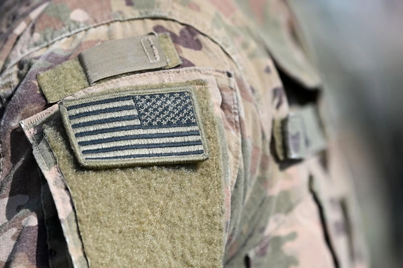 A soldier of the US army wears the country's flag on his uniform during the 'Dynamic Front 22', the US Army led NATO and Partner integrated annual artillery exercise in Europe, in Grafenwoehr, near Eschenbach, southern Germany, on July 20, 2022. The 'Dynamic Front 22' exercise, led by 56th Artillery Command, is the premier US led NATO and Partner integrated artillery exercise in Europe and includes more than 3000 participants from 19 nations. Allied artillery and supporting units practice integrating joint fires and test interoperability in a multi-national enviroment until 24 July, 2022. (Photo by Christof STACHE / AFP) (Photo by CHRISTOF STACHE/AFP via Getty Images)