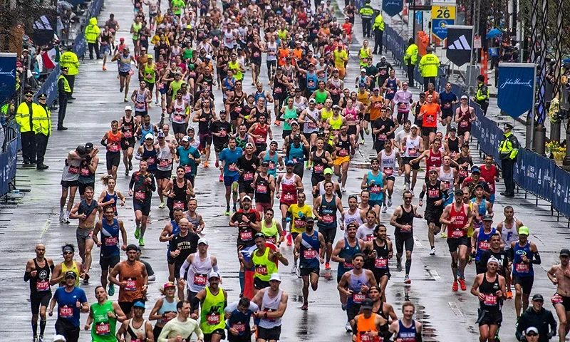 Thousands of runners make their way to the finish line during the 127th Boston Marathon in Boston, Massachusetts on April 17, 2023. - In wet and windy conditions, 2022 champion Chebet of Kenya took his time before surging away in the closing stages to become the first man to defend the Boston crown since compatriot Robert Kipkoech Cheruiyot completed a hat trick of victories between 2006-2008. (Photo by Joseph Prezioso / AFP) (Photo by JOSEPH PREZIOSO/AFP via Getty Images)
