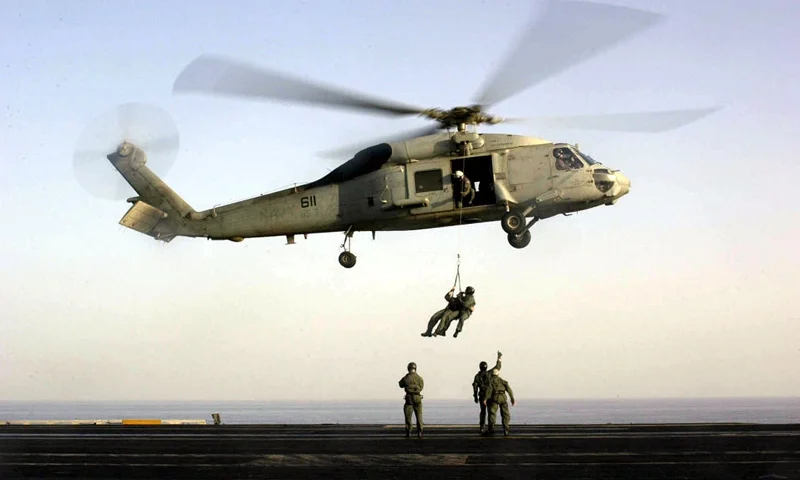396169 14: US Navy SEALs train with an SH-60F "Seahawk" helicopter October 18, 2001 on the flight deck of USS Enterprise. Aircraft from the Enterprise are being used to attack targets within Afghanistan. (Photo by Lance H. Mayhew Jr./US Navy/Getty Images)