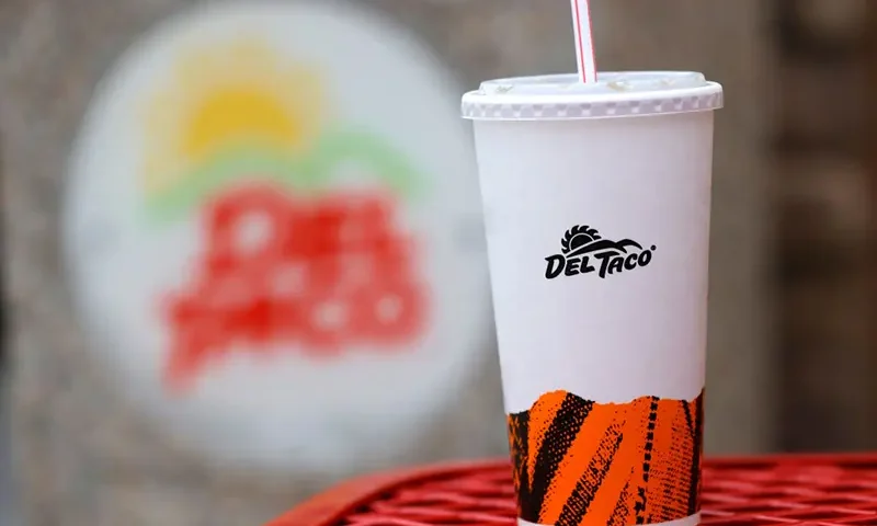In this photo illustration, a soft drink cup is displayed with the Del Taco logo at a Del Taco restaurant on December 06, 2021 in Fairfield, California. Jack in the Box announced plans to buy California based Mexican fast-food chain Del Taco in a deal worth $575 million. (Photo Illustration by Justin Sullivan/Getty Images)