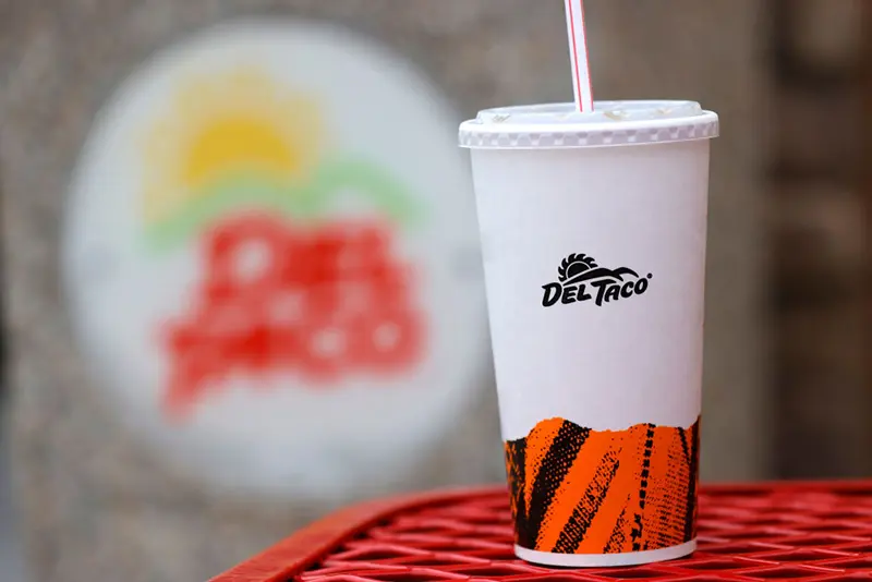 In this photo illustration, a soft drink cup is displayed with the Del Taco logo at a Del Taco restaurant on December 06, 2021 in Fairfield, California. Jack in the Box announced plans to buy California based Mexican fast-food chain Del Taco in a deal worth $575 million. (Photo Illustration by Justin Sullivan/Getty Images)