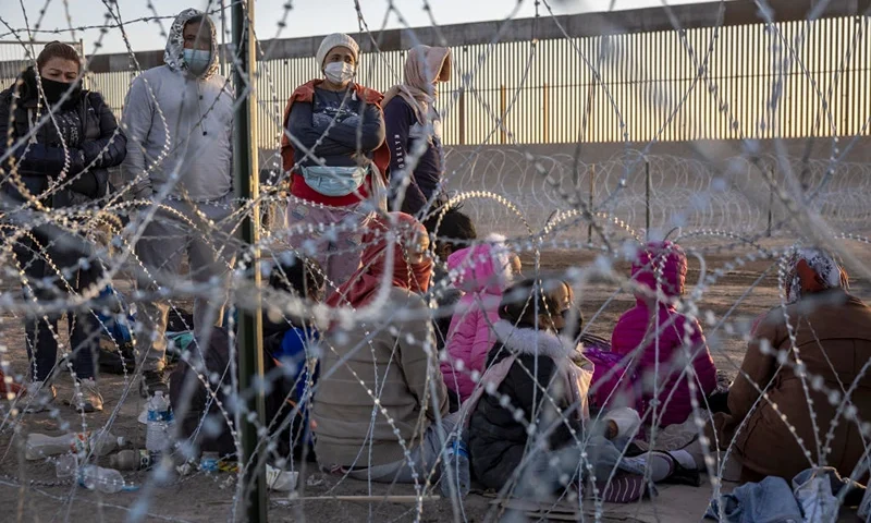 EL PASO, TEXAS - MAY 12: Immigrants wait to be processed by U.S. Border Patrol agents at an encampment near the U.S.-Mexico border fence on May 12, 2023 in El Paso, Texas. The U.S. Covid-era Title 42 immigration policy ended the night before, and migrants entering the system now are anxious over how the change may affect their asylum claims. (Photo by John Moore/Getty Images)