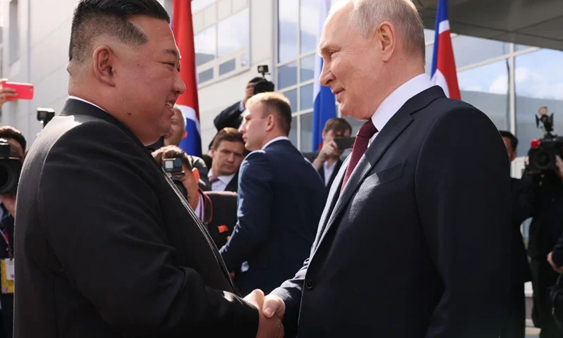 TOPSHOT - In this pool photo distributed by Sputnik agency, Russia's President Vladimir Putin (R) shakes hands with North Korea's leader Kim Jong Un (L) during their meeting at the Vostochny Cosmodrome in Amur region on September 13, 2023. Russian President Vladimir Putin and North Korean leader Kim Jong Un both arrived at the Vostochny Cosmodrome in Russia's Far East, Russian news agencies reported on September 13, ahead of planned talks that could lead to a weapons deal. (Photo by Mikhail METZEL / POOL / AFP) (Photo by MIKHAIL METZEL/POOL/AFP via Getty Images)