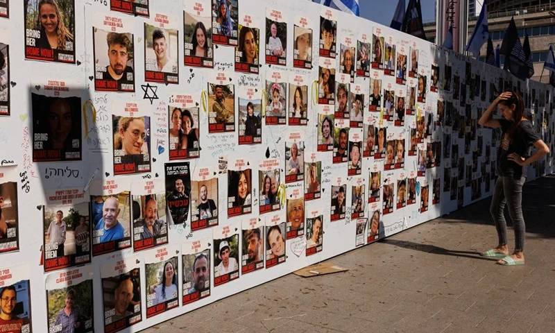 TEL AVIV, ISRAEL - OCTOBER 26: A member of the public looks at a wall displaying pictures of people still held hostage in Gaza, on October 26, 2023 in Tel Aviv, Israel. In the wake of the Oct. 7 attacks by Hamas that left an estimated 1,400 dead and 200 kidnapped, Israel launched a sustained bombardment of the Gaza Strip and threatened a ground invasion to vanquish the militant group that governs the Palestinian territory. But the fate of the hostages, Israelis and foreign nationals who are being held by Hamas in Gaza, as well as international pressure over the humanitarian situation in Gaza, have complicated Israel's military response to the attacks. A timeline for a proposed ground invasion remains unclear. (Photo by Dan Kitwood/Getty Images)
