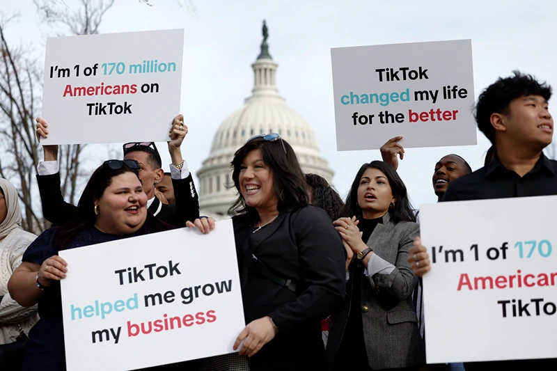 WASHINGTON, DC - MARCH 13: Participants hold signs in support of TikTok outside the U.S. Capitol Building on March 13, 2024 in Washington, DC. The House of Representatives will vote Wednesday on whether to ban TikTok in the United States due to concerns over personal privacy and national security unless the Chinese-owned parent company ByteDance sells the popular video app within the next six months. (Photo by Anna Moneymaker/Getty Images)