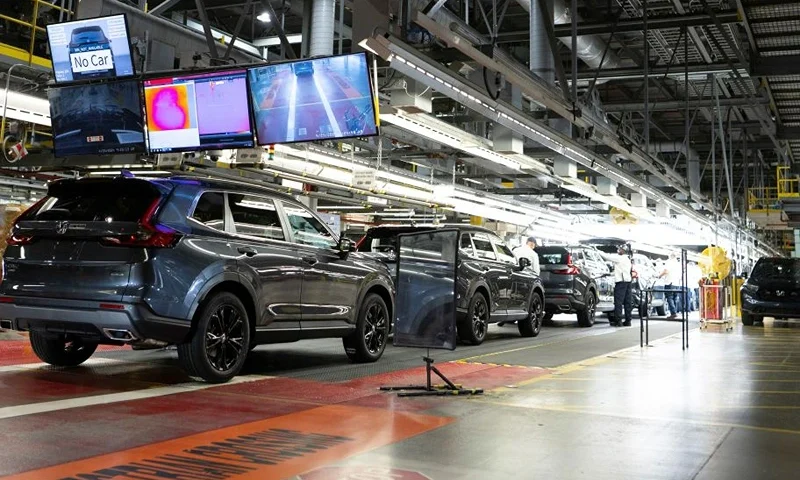 Workers continue vehicle assembly shortly before the line was shut down for an event at the Honda of Canada Manufacturing Plant 2 in Alliston, Ontario, on April 25, 2024 where it was announced that Japanese automaker Honda will make the largest automotive investment in Canada's history worth Can$15 billion (US$11 billion) electric vehicle investment in Ontario that will see four new manufacturing plants built in the province. (Photo by Peter Power / AFP) (Photo by PETER POWER/AFP via Getty Images)