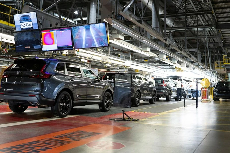 Workers continue vehicle assembly shortly before the line was shut down for an event at the Honda of Canada Manufacturing Plant 2 in Alliston, Ontario, on April 25, 2024 where it was announced that Japanese automaker Honda will make the largest automotive investment in Canada's history worth Can$15 billion (US$11 billion) electric vehicle investment in Ontario that will see four new manufacturing plants built in the province. (Photo by Peter Power / AFP) (Photo by PETER POWER/AFP via Getty Images)