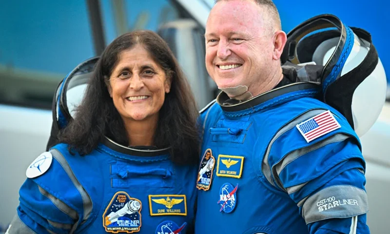 NASA astronauts Butch Wilmore (R) and Suni Williams, wearing Boeing spacesuits, depart the Neil A. Armstrong Operations and Checkout Building at Kennedy Space Center for Launch Complex 41 at Cape Canaveral Space Force Station in Florida to board the Boeing CST-100 Starliner spacecraft for the Crew Flight Test launch , on June 5, 2024. Boeing on June 5 will try once more to launch astronauts aboard a Starliner capsule bound for the International Space Station. Liftoff is targeted for 10:52 am (1452 GMT) for a roughly one-week stay at the orbital laboratory. (Photo by Miguel J. Rodriguez Carrillo / AFP) (Photo by MIGUEL J. RODRIGUEZ CARRILLO/AFP via Getty Images)