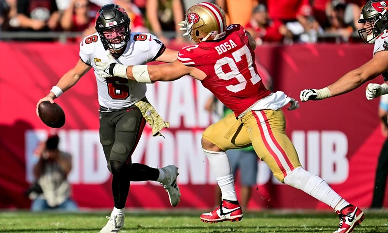 TAMPA, FLORIDA - NOVEMBER 10: Baker Mayfield #6 of the Tampa Bay Buccaneers runs with the ball against Nick Bosa #97 of the San Francisco 49ers during the fourth quarter at Raymond James Stadium on November 10, 2024 in Tampa, Florida. (Photo by Julio Aguilar/Getty Images)