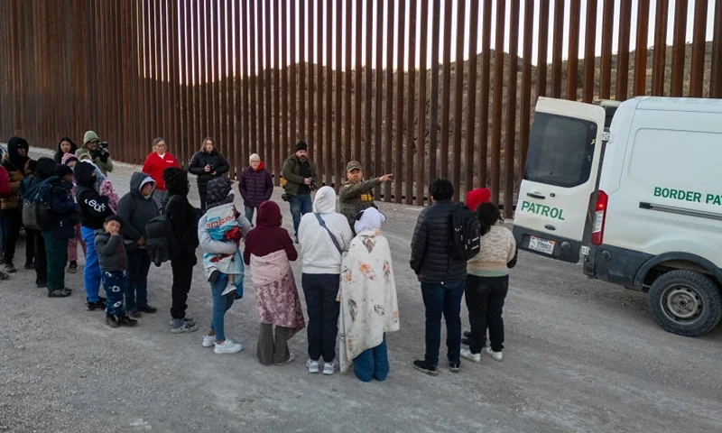 SASABE, ARIZONA - JANUARY 20: Immigrants wait to be transported by U.S. Border Patrol agents after crossing the U.S.-Mexico border on January 20, 2025 near Sasabe, Arizona. Immigrant families had passed through a gap in the Trump-built border wall hours before Donald J. Trump was inaugurated for a second time as President of the United States. (Photo by John Moore/Getty Images)