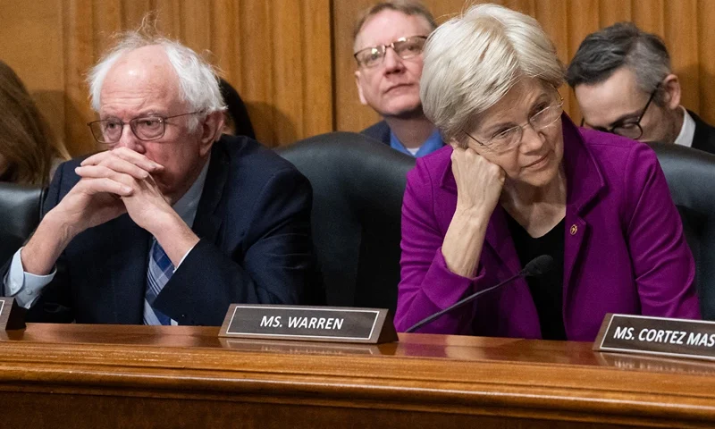 TOPSHOT - US Senator Bernie Sanders (L), Independent of Vermont, and US Senator Elizabeth Warren (R), Democrat of Massachusetts, attend a US Senate Finance Committee business meeting on the nomination of Robert F. Kennedy, Jr. to be Secretary of Health and Human Services, on Capitol Hill in Washington, DC, February 4, 2025. US President Donald Trump's embattled health secretary pick, vaccine conspiracy theorist Robert F. Kennedy Jr, passed a crucial test in his confirmation bid on Tuesday as senators voted to advance his nomination to the floor. (Photo by SAUL LOEB / AFP) (Photo by SAUL LOEB/AFP via Getty Images)