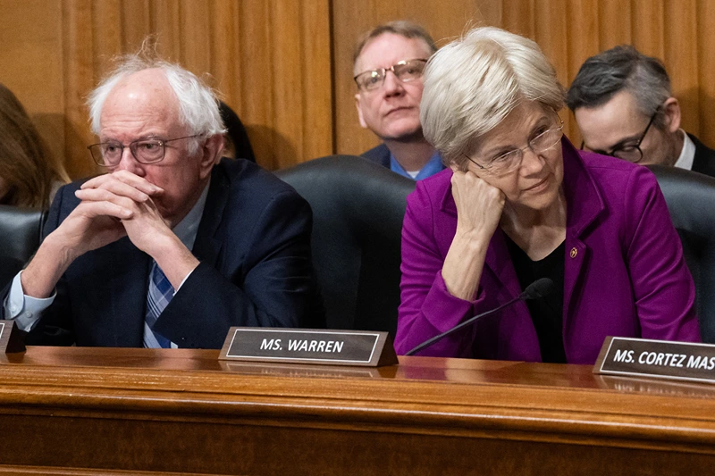 TOPSHOT - US Senator Bernie Sanders (L), Independent of Vermont, and US Senator Elizabeth Warren (R), Democrat of Massachusetts, attend a US Senate Finance Committee business meeting on the nomination of Robert F. Kennedy, Jr. to be Secretary of Health and Human Services, on Capitol Hill in Washington, DC, February 4, 2025. US President Donald Trump's embattled health secretary pick, vaccine conspiracy theorist Robert F. Kennedy Jr, passed a crucial test in his confirmation bid on Tuesday as senators voted to advance his nomination to the floor. (Photo by SAUL LOEB / AFP) (Photo by SAUL LOEB/AFP via Getty Images)