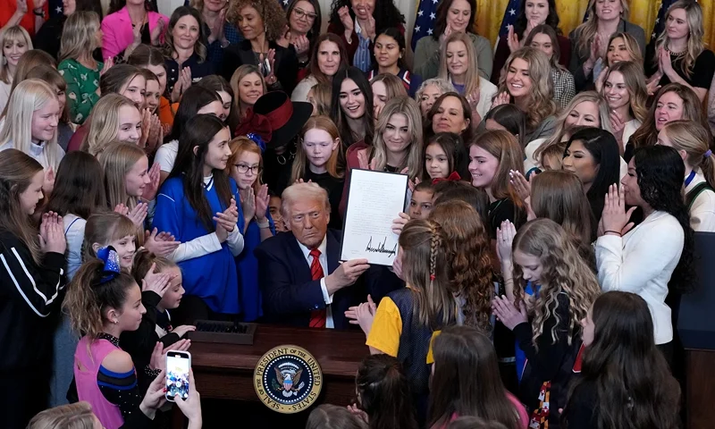 WASHINGTON, DC - FEBRUARY 05: U.S. President Donald Trump joined by women athletes signs the “No Men in Women’s Sports” executive order in the East Room at the White House on February 5, 2025 in Washington, DC. The executive order, which Trump signed on National Girls and Women in Sports Day, prohibits transgender women from competing in women’s sports and is the third order he has signed that targets transgender people. (Photo by Andrew Harnik/Getty Images)