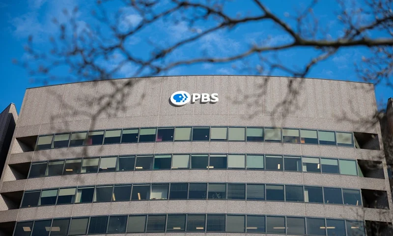 ARLINGTON, VA - FEBRUARY 18: A sign for the Public Broadcasting Service (PBS) is seen on its building headquarters on February 18, 2025 in Arlington, Virginia. The federal government's partial funding of the Public Broadcasting Service is now being examined by Elon Musk's U.S. Department of Government Efficiency (DOGE). Rep. Marjorie Taylor Greene (R-GA) has also called upon the head of PBS to testify in front of Congress next month on alleged news bias. (Photo by Kayla Bartkowski/Getty Images)