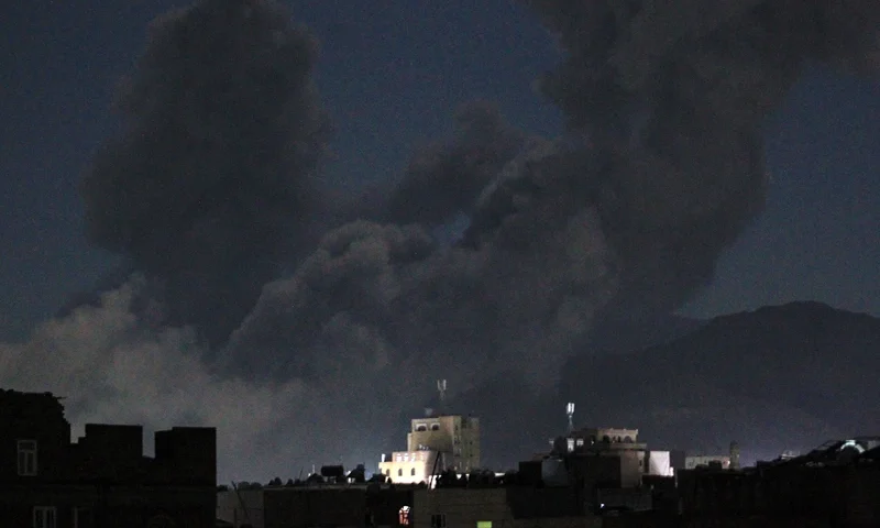 A plume of smoke billows during a US strike on Yemen's Huthi-held capital Sanaa early on March 16, 2025. The first US strikes against Yemen's Huthis since President Donald Trump took office in January killed at least 31 people, the rebels said on March 16, as Washington warned Iran to stop backing the group. (Photo by Mohammed HUWAIS / AFP) (Photo by MOHAMMED HUWAIS/AFP via Getty Images)