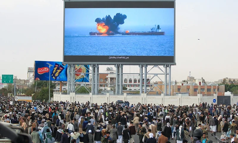 TOPSHOT - Images of a fireball exploding on a cargo ship are shown on a giant screen during a protest called for by Yemen's rebel Huthi movement in Sanaa on March 17, 2025. Huge crowds joined protests in rebel-controlled Yemen on March 17 after deadly US strikes killed dozens and sparked fears of a new cycle of violence in the conflict-torn country. (Photo by Mohammed HUWAIS / AFP) (Photo by MOHAMMED HUWAIS/AFP via Getty Images)