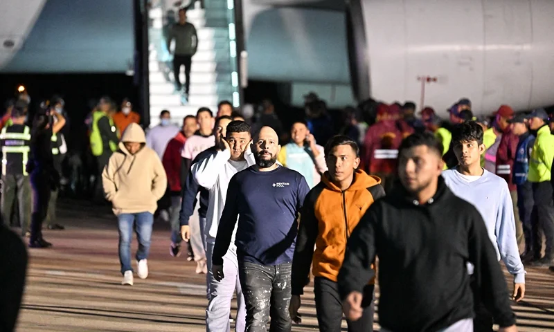 Venezuelan migrants deported from the United States and stranded in Honduras disembark from a Conviasa Airlines plane upon arrival at Simon Bolivar International Airport in Maiquetia, Venezuela on March 24, 2025. (Photo by JUAN BARRETO / AFP) (Photo by JUAN BARRETO/AFP via Getty Images)